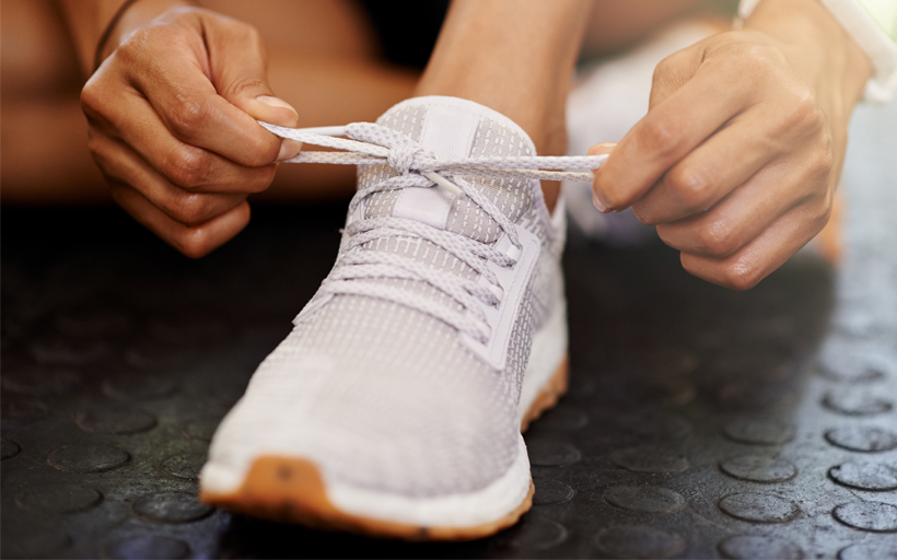 Cropped Shot of a Woman Tying Her Shoelaces