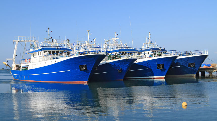 parked blue boats beside dock